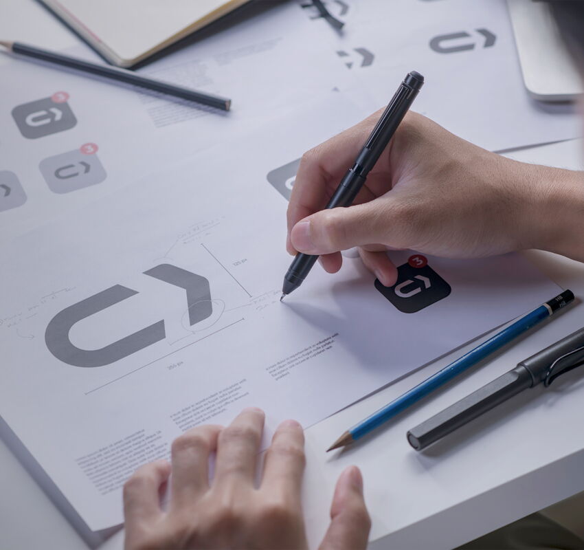 graphic designer sketching logos and icons for a tech company