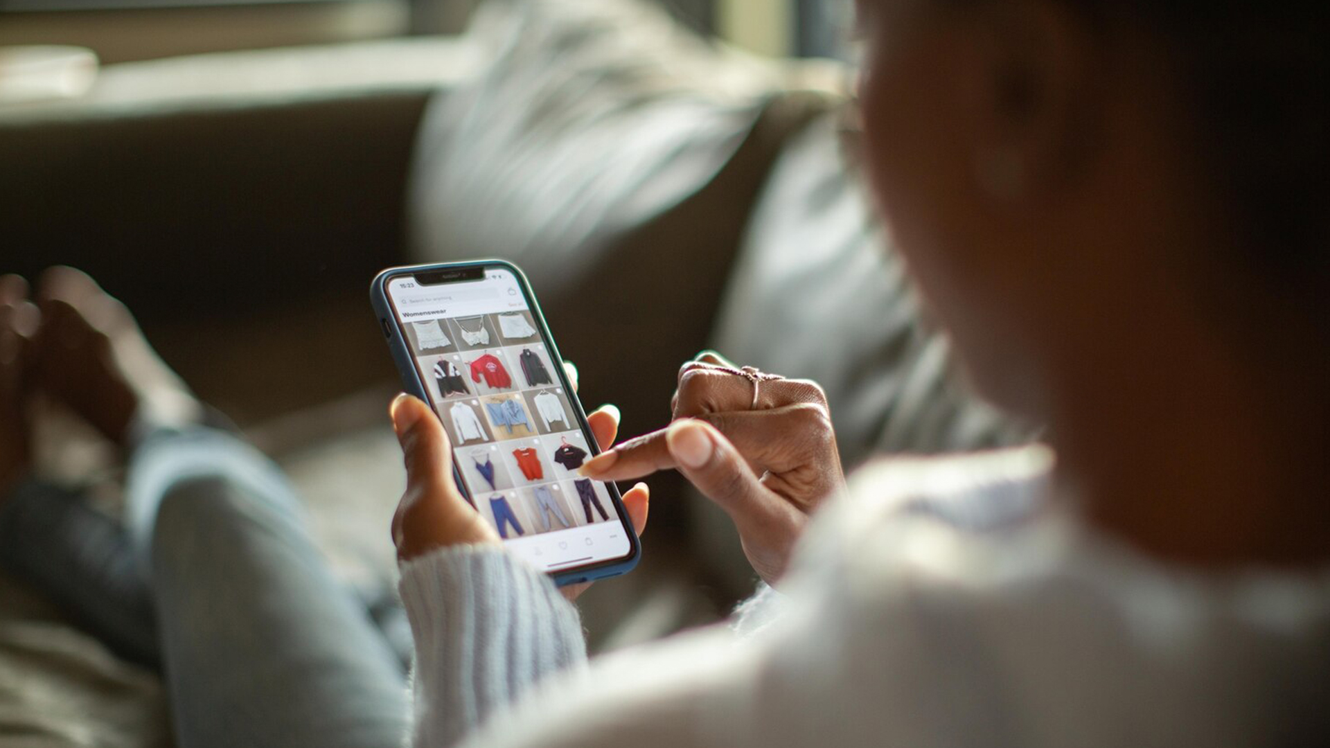 woman searching for local retail shops near her for clothes on mobile phone